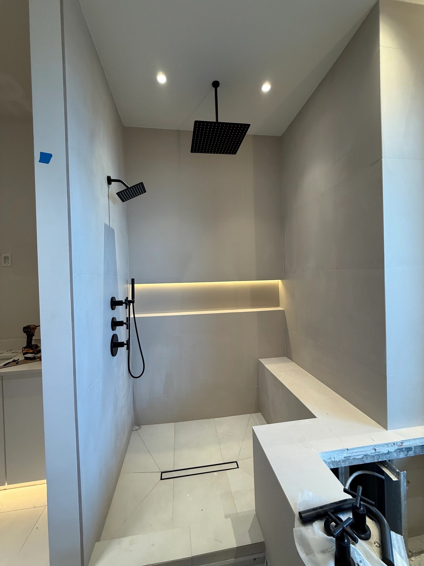 Modern shower with bench and black finishes