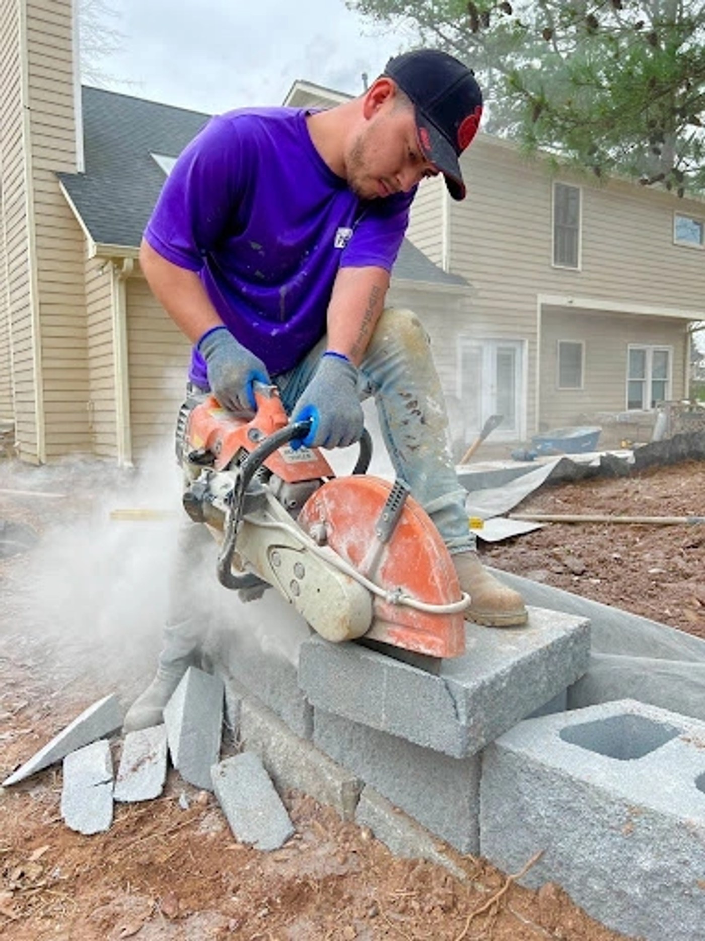 Worker cutting concrete block on the job site