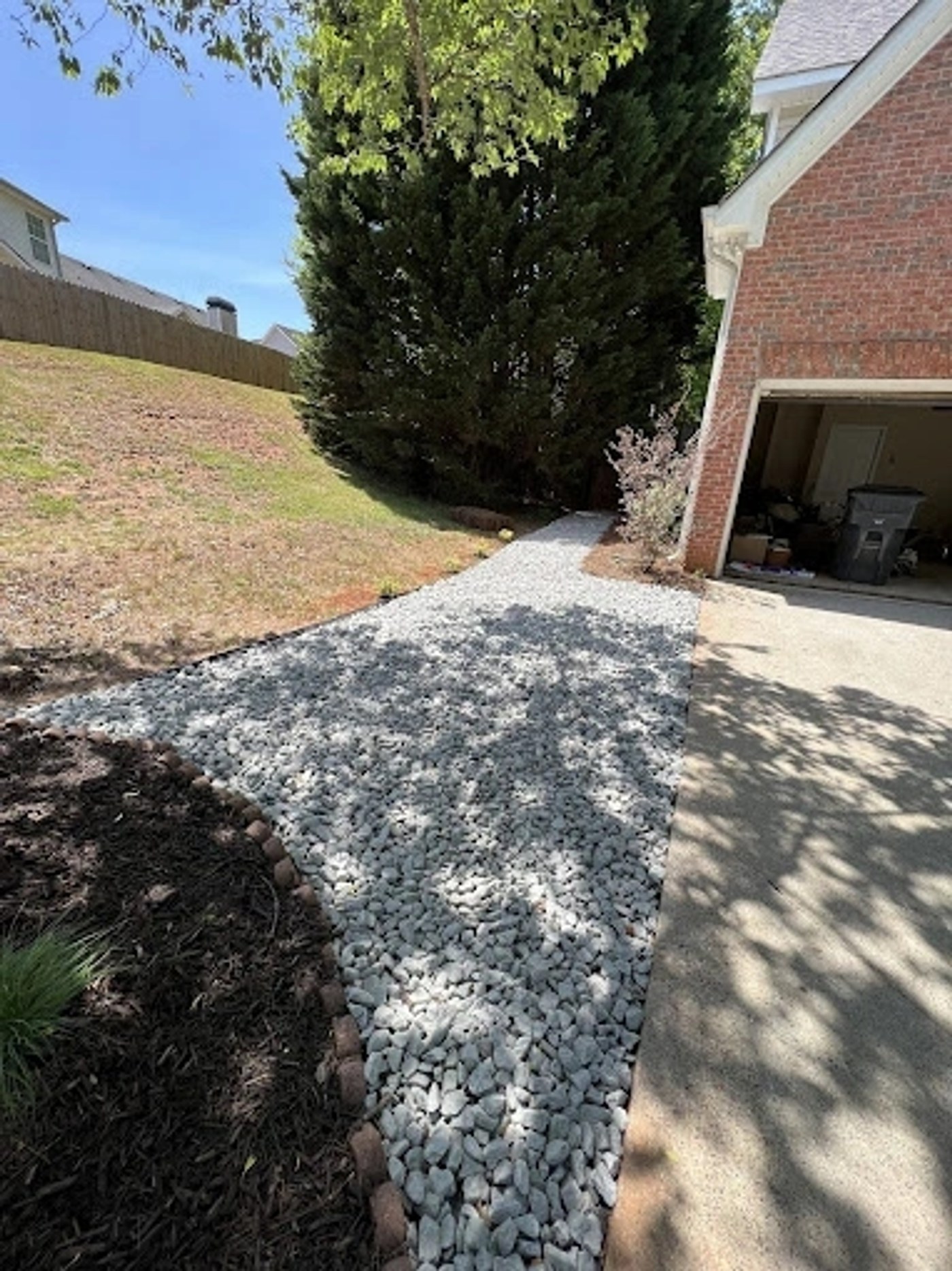 Finished gravel driveway and landscaping at a residence
